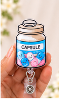 Happy Little Capsule Shaker badge reel