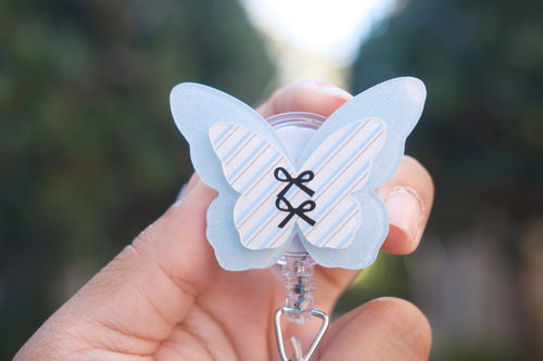 Blue Butterfly with Black Bows Badge Reel