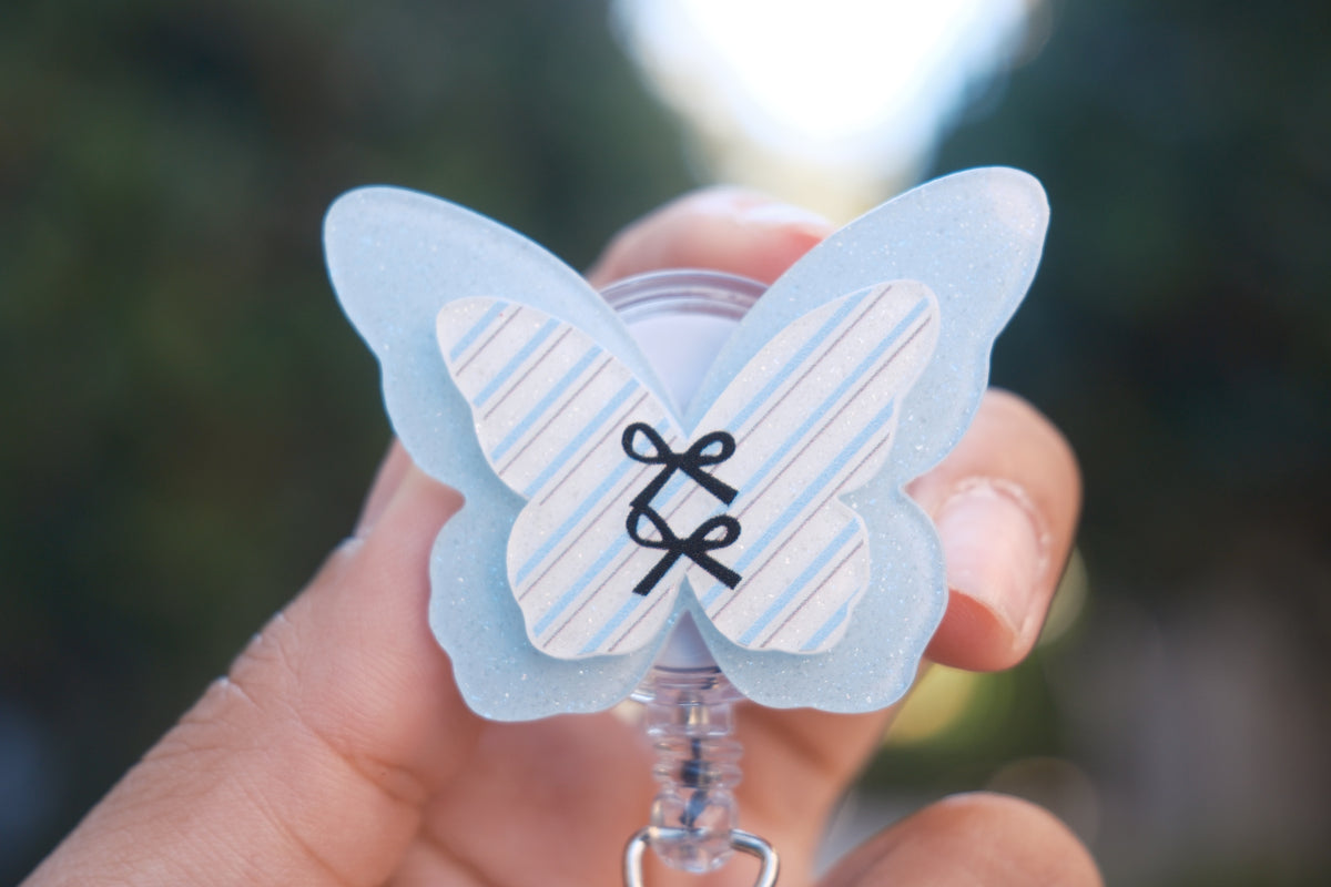 Blue Butterfly with Black Bows Badge Reel