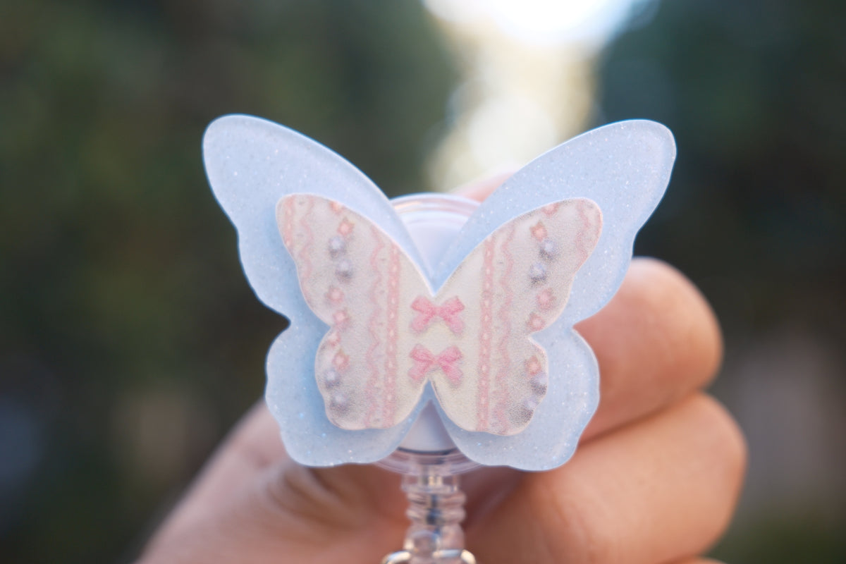 Blue Glitter Butterfly with Coquette Details Badge Reel