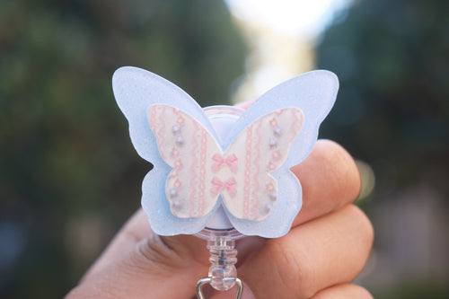 Blue Glitter Butterfly with Coquette Details Badge Reel