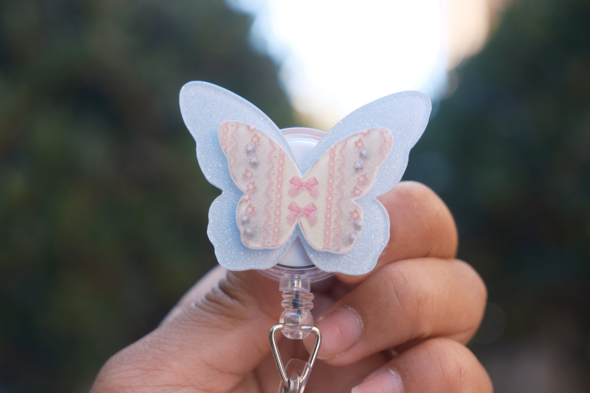 Blue Glitter Butterfly with Coquette Details Badge Reel
